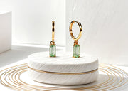 Stylish hoop earrings featuring a precision-cut green gemstone for a fresh, modern look